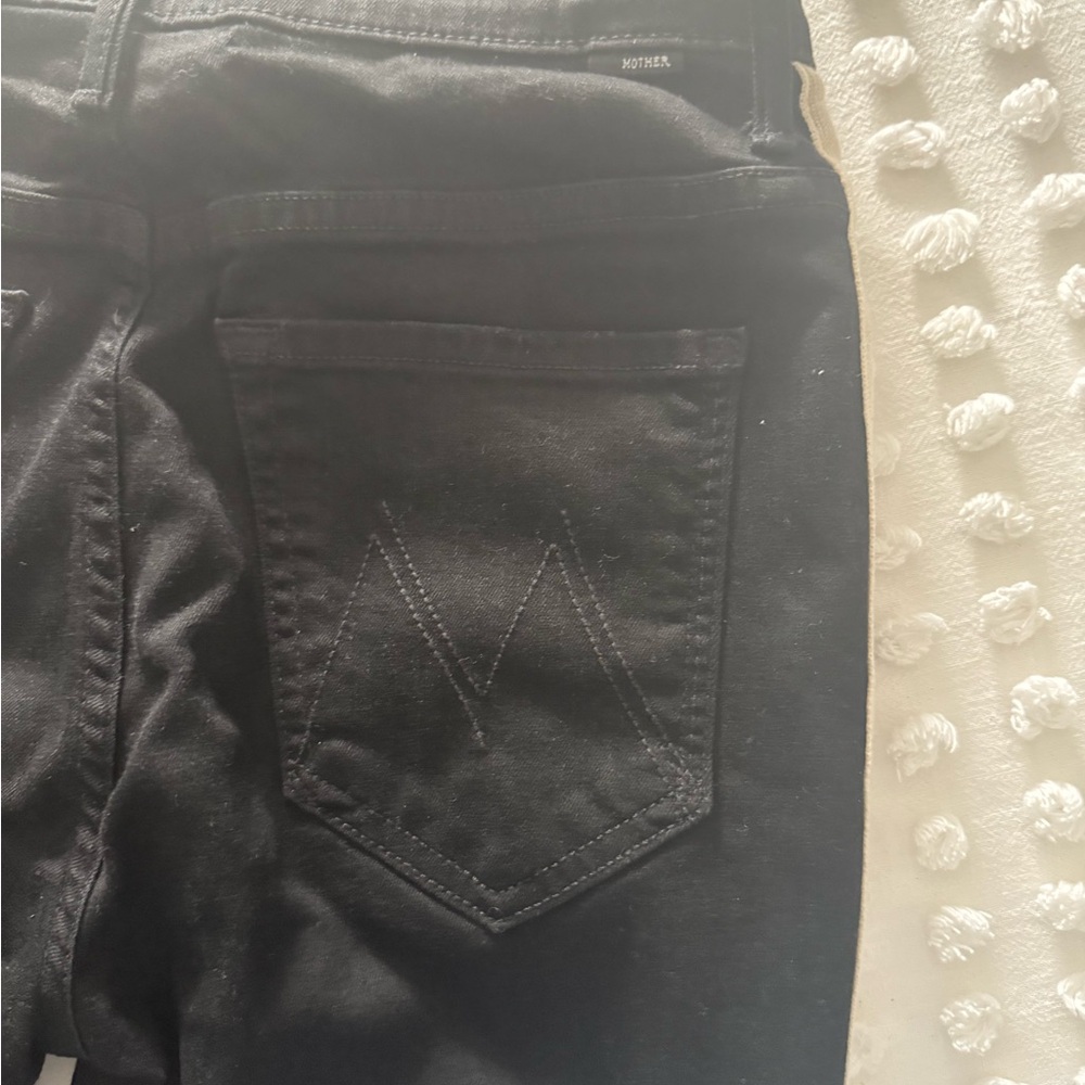 Mother black jeans with cream racing strip down the legs.